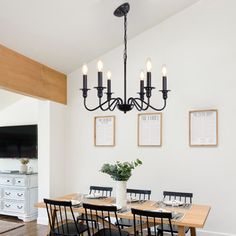 the dining room table is set with black chairs