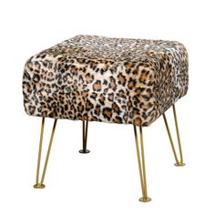 an animal print ottoman with gold legs