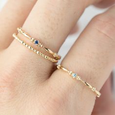 This dainty birthstone stackable ring is unlike any other, the band has a unique design all around which gives a bit of antique feel. Perfect gift for July birthdays! * Stock size: US 7 * Genuine 1.5mm blue sapphire * Band width: ≈1.75mm * Setting size: ≈2mm * Material: 14k solid yellow gold (rose gold or white gold option available) * Made of 100% recycled precious metal and ethically sourced gemstone * Comes in a gift box with a bow ready for gifting * Handmade with love and great care in New Dainty Sapphire Birthstone Promise Ring, Dainty Sapphire Solitaire Ring, Gold Stackable Rings With Sapphire Bezel Setting, Gold Sapphire Stackable Rings With Bezel Setting, Everyday Gold Stackable Sapphire Ring, Dainty Sapphire Diamond Ring, Yellow Gold Sapphire Stackable Rings With Bezel Setting, Sapphire Birthstone Dainty Ring, Dainty 14k Gold Diamond Birthstone Ring