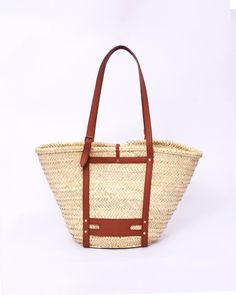 Do you want to look stylish and hippy? Get your hands on this handmade straw bag. It's high quality, eco-friendly, and handcrafted by women in Morocco. Its design is unique and timeless. Get yours now! we are proud to introduce our signature straw french bag to you. it is handmade by our talented artisan who has been working with us for years. this beautiful bag has a unique design that you would find nowhere else. the light and durable material are ideal for taking the bag on your adventures. S Everyday Natural Straw Bag With Leather Trim, Bohemian Brown Straw Bag For Vacation, Casual Straw Bag With Leather Trim For Travel, Spring Travel Bag With Leather Trim, Natural Straw Tote Bag With Leather Trim, Natural Straw Bag With Leather Trim, Casual Style, Bohemian Brown Bucket Bag For Beach Season, Bohemian Natural Bucket Bag For Summer, Brown Bohemian Bucket Bag For Beach Season