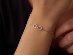 🌟 14K Gold Infinity Bracelet 🌟 Celebrate endless love and connection with our 14K Gold Infinity Bracelet. This elegant piece symbolizes eternity and the unbreakable bonds we cherish. The delicate infinity symbol shines brightly on your wrist, adding a touch of timeless beauty to any outfit. ✨ Available in three stunning colors--classic yellow gold, warm rose gold, and sleek white gold--this bracelet can be customized to reflect your unique style. With lengths ranging from 6 inches to 8.5 inche Sleek Bracelet For Women, Yellow Gold Infinity Bracelets For Everyday, Yellow Gold Infinity Bracelet For Everyday, 14k Gold Infinity Bracelet For Anniversary, Dainty Infinity Yellow Gold Bracelets, Dainty Yellow Gold Infinity Bracelet, 14k Gold Infinity Bracelet Gift, Minimal Gold Bracelet, Infinity Bracelet Gold