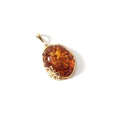 It takes my breath away! The beautiful sparkling Cognac Amber with the gold frame around the pendant is just a gorgeous combination! Due to inherent nature of natural stones, there may be slight variation in stone sizes, shapes, colors and patterns. Stones: Golden Cognac Amber Dimensions: Amber stone is approx. 1" long x 3/4" wide length: Pedant hangs approx. 1 1/2" Material: Gold Plated Sterling Silver Made in: Poland