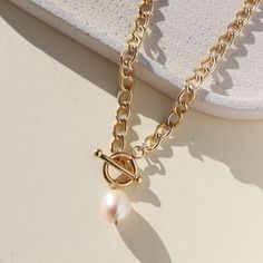 A twist on our classic Alexandra Choker, this necklace features a toggle clasp with a pearl detail and is already a fave with everyone on the Token team. DETAILS14k gold fillAvailable in 16" or 18” with toggle clasp and 0.5" pearlHypoallergenic, waterproof, and nickel free Luxury Gold Toggle Clasp Necklace, Classic Pearl Jewelry, Rose Gold Gifts, Gold Jewelry Gift, Toggle Necklace, Forever Jewelry, Jewelry Card, Solid Gold Jewelry, Handmade Fashion