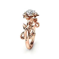 a rose gold ring with a diamond in the center and vines on the band, set against a white background