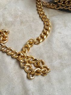 24x16 mm curb metal chain with a shiny, metallic gold finish. This iron chain features closely-knit linked chains that have subtle distresses carved into the metal Metal Chain Ring With Link Shape, Metal Chain Ring With Gold Link Chain, Gold Chain Link Ring Made Of Metal, Gold Metal Chain Link Ring, Gold Metal Link Chain Ring, Formal Gold Metal Chain Ring, Metal Oval Link Chain Ring, Brass Chain Link Bracelet With Gold Chain Detail, Brass Gold Chain Link Bracelet