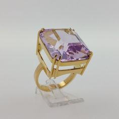 "18k. Yellow gold ring with spectacular natural kunzite of 36.75 carat Rectangle shaped purplish pink Kunzite with CGS certificate This gorgeous ring handcrafted by \"Zodiny Jewellery\" of 18k. yellow gold set with spectacular natural Kunzite of 36.75 carat. Kunzite is a beautiful stone to look at, with a gentle, almost heavenly appearance. This finest quality Kunzite has fine purplish pink colour. Stone: natural spodumene, variety kunzite Shape and cut: Rectangular step cut Carat weight: 36.75 Gold Rectangular Amethyst Ring For Formal Occasions, Luxury Rectangular Amethyst Ring Gift, Luxury Rectangular Amethyst Ring For Gift, Luxury Rectangular Amethyst Ring As A Gift, Elegant Rectangular Amethyst Ring In Yellow Gold, Luxury Rectangular Pink Rings, Luxury Pink Rectangular Rings, Formal Pink Amethyst Ring, Formal Pink Rings With Rectangular Stone