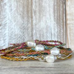 With a kiss of golden sun, this beautiful Beso del Oro bracelet is sure to add a touch of sparkle to your life! We weave one beautifully imperfect freshwater baroque pearl with gold and your choice of colorful waxed cord together to create this casual yet stylish piece. The closure is a simple tie on slide knot for easy on and off and is so soft and comfortable you'll forget you're wearing it and makes a great sparkly addition to any stacker ensemble! This bracelet/anklet is completely waterproo Gold Bracelets With Round Beads For Vacation, Gold Spiritual Friendship Bracelets For Festivals, Gold Spiritual Friendship Bracelet For Festivals, Gold Bracelet With Pearl Charm For Beach, Gold Spiritual Jewelry For Vacation, Gold Pearl Charm Bracelet For Beach, Adjustable Gold Pearl Bracelet For Summer, Gold Pearl Bracelet With Pearl Charm For Beach, Adjustable Beaded Bracelets With Pearl Charm For Beach