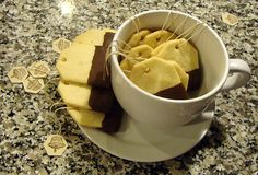 a cup filled with chocolate and marshmallows on top of a counter