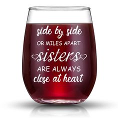 a wine glass that says side by side or miles apart sisters are always close at heart