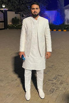 Our esteemed happy client, Pakistani star cricketer Mr. Faheem Ashraf looking absolutely stunning in open front white prince coat with kurta pajama designed by Uomo Atire.

- It's custom-made, so it's guaranteed to fit you perfectly. White Nehru Jacket For Diwali Reception, White Nehru Jacket For Reception Diwali, White Naqshi Salwar Kameez For Reception, Eid Reception Jamawar Bandhgala, White Bollywood Style Nehru Jacket For Reception, Eid Nehru Jacket With Dupatta For Reception, White Nehru Jacket With Dupatta For Eid, White Fitted Jamawar Bandhgala, Elegant Unstitched White Suit