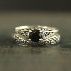 two silver rings with a black stone in the middle