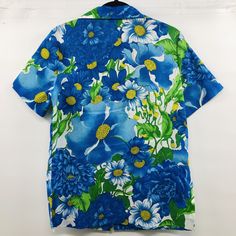 "Beautiful floral vintage 1960's button down short sleeved blouse. Crepe like feel. Side slits. Beautiful attention to detail in the tailoring. Good vintage condition, No stains rips or smells. Measured flat: 20.5\" pit to pit, 29\" overall length. Would fit up Women's Large if worn open." Vintage Short Sleeve Blouse With Retro Print, Spring Retro Print Short Sleeve Camp Shirt, Retro Fitted Hawaiian Shirt For Spring, Retro Button-up Short Sleeve Shirt For Spring, Fitted Short Sleeve Hawaiian Shirt, Short Sleeve Camp Shirt With Retro Print For Spring, Retro Blue Camp Shirt For Spring, Retro Collared Hawaiian Shirt With Button Closure, Retro Short Sleeve Camp Shirt For Spring