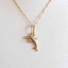 Dolphin charm.  Dolphin gold charm. 9 carat yellow gold charm.  It can be worn on a chain or a bracelet. The charm measures 1.4x1.3cms The charm is ready to ship in 1-2 working days.   All my pieces come in a velvet ring box.  I am highly conscious of environmental damage that extra packaging can create so my pieces come in appropriate jewellery box only with ho extra packaging. This item qualifies for free shipping. Yellow Gold-plated Charms With Lobster Clasp, Gold Pendant Charms With Dainty Style, Gold Dainty Pendant Charms, Dainty Gold Pendant Charms, Yellow Gold Charm Bracelet With Dangle Shape, Gold-plated Pendant Charms, 14k Yellow Gold Tarnish Resistant Charm Necklace, Yellow Gold Plated Pendant Charms, Yellow Gold Dangle Charms For Gifts