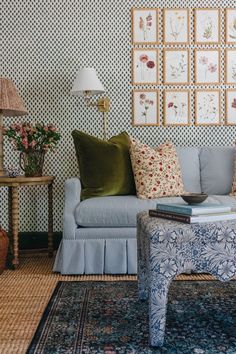 a living room filled with furniture and pictures on the wall above it's coffee table