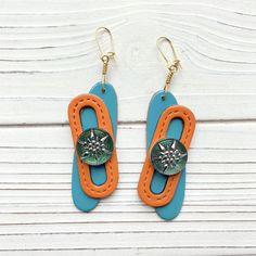 "Intricately fashioned leather and Czech glass buttons create these stylish artsy earrings. 3.75\" drop. Gold-plated, nickel-free ear wires. 3.75\" drop. Very lightweight earrings. Handmade in the USA." Artsy Earrings, Orange And Turquoise, Lightweight Earrings, Glass Buttons, Light Weight Earrings, Beautiful Bags, Ear Wires, Czech Glass, Earrings Handmade