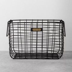 a metal basket sitting on top of a cement floor