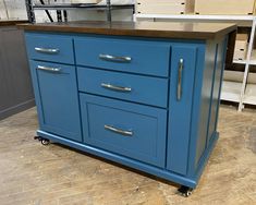 a blue kitchen island on wheels in a store