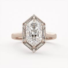 an old - fashioned diamond engagement ring with baguets in rose gold and diamonds