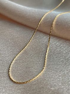 Your ultimate versatile queen, Audrey is minimal and reflective and will be the anchor of any look! The low profile and high shine of this chain gives Audrey the most dainty and delicate vibes of all of our chains. Understated and elegant on their own and an absolute essential in any layered necklace look, you can't go wrong with Serendipity chains! ........................... NECKLACE SIZE & MATERIAL❋ 17" chain with a 2" extender❋ 14k gold plated brass❋ nickel free Dainty Link Chain Necklace With Clavicle Chain, Minimalist Tarnish Resistant Snake Chain Necklace, Dainty Link Chain Necklace For Everyday, Everyday Dainty Link Chain Necklace, Minimalist Clavicle Chain Necklace, Chic 14k Gold Chain Necklace With Delicate Chain, Delicate Clavicle Chain Link Necklace, Minimalist Clavicle Chain Link Necklace, Timeless Cable Chain Necklace As Gift