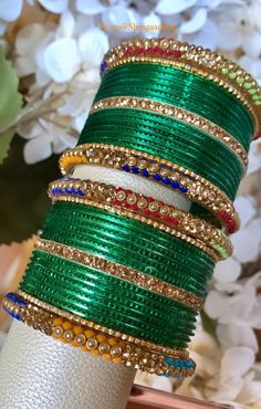 Beautiful simple yet elegant bangle set.  Only available in size 2.4 only.  You will receive 24 green bangles, 4 side bangles and 6 accent bangles as shown in images. Color, shades, texture displayed may slightly vary from the actual product due to digital image limitations. Care: It is advisable that you keep our products away from direct heat, humidity, and moisture.  Please do not use Perfume/spray on the products. We at ShingaarBox doing our best to keep all our products clean and sanitized.  Thank you for your business and stay safe. Bohemian Jewelry With Zari Work For Festive Season, Bohemian Jewelry With Zari Work For Diwali, Green Zari Work Bangle Bracelet, Bohemian Zari Work Jewelry Gift, Green Bangle Bracelets For Wedding, Green Metal Bangle Jewelry, Green Metal Bracelets For Festive Occasions, Green Jewelry With Stone Work For Diwali, Green Bangle With Zari Work