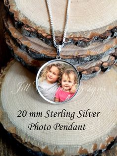 two children are shown in the center of this photo pendant