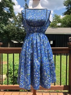 "Such a pretty blue floral dress! I love the accordion bib outlined in black rickrack trim. This dress can be transitioned from spring-autumn in my opinion. Just add a cropped cardigan for a more vintage look or a fitted denim jacket for something more hipster! You will most likely need a slip as she is fairly sheer. For the future owner: Please send picture, because I LOVE this one! Excellent vintage condition! Measurements taken flat, please double: Bust 19\" Waist 13\" Length 38\" All sales a Vintage Midi Dress For Daywear In Spring, Vintage A-line Dress For Day Out, Vintage A-line Dress For Spring Dress Down, Spring Vintage A-line Dress For Casual Occasions, Spring A-line Vintage Dress For Dress Down Occasions, Spring A-line Vintage Dress For Casual Occasions, Retro Square Neck Spring Dresses, Spring Vintage Fit And Flare Knee-length Dress, Spring Knee-length Fit And Flare Vintage Dress