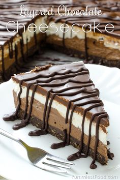 a piece of cake with chocolate drizzled on it and a fork next to it