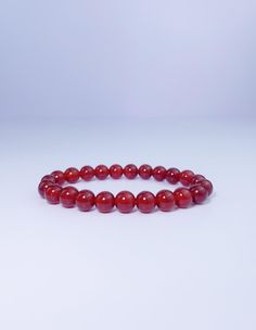 This carnelian bracelet is the perfect way to keep your energy high and your mood positive. The vibrant red stone is said to promote joy, happiness, and creativity, while also providing protection from negative energy. Wear it as a reminder to stay positive and focused on your goals. Red Carnelian Beaded Bracelet With Round Beads, Red Carnelian Beaded Bracelets With Round Beads, Red Carnelian Round Beads Bracelet, Red Carnelian Beaded Bracelets With Gemstone Beads, Red Carnelian Bracelets With 8mm Beads, Amber Carnelian Beaded Bracelets - Gift, Amber Carnelian Beaded Bracelet Gift, Red Round Bracelets For Meditation, Red Carnelian Beaded Bracelets