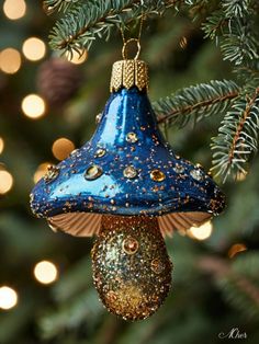 a blue ornament hanging from a christmas tree