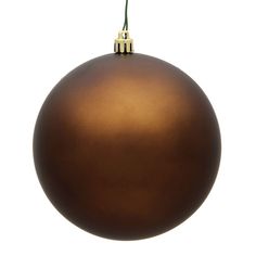 a shiny brown ornament hanging from a green twig on a white background