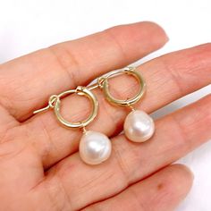 Petite huggie hoops featuring white fresh water pearls dangle. Gold filled hoops are 13mm in size. Genuine fresh water pearls are 9-10mm. Everyday Teardrop Huggie Earrings With Pearl Drop, Teardrop Pearl Drop Huggie Earrings, White Pearl Charm Hoop Earrings, White Pearl Hoop Earrings With Pearl Charm, Pearl Charm Huggie Earrings, Small Hoop Pearl Earrings, Hypoallergenic Pearl Huggie Hoop Earrings, Small Hoop Earrings With Pearl Charm, Everyday Pearl Earrings With Pearl Charm