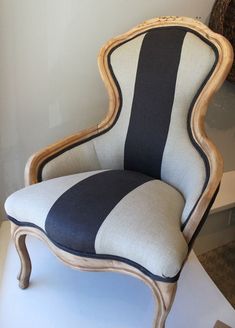 a chair with black and white striped upholstered on it's back end