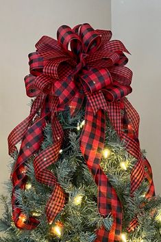 a christmas tree with red and black plaid bows