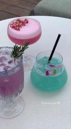 three different types of cocktails sitting on top of a white table next to each other