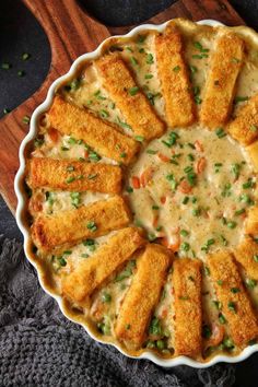 a casserole dish filled with cheese and vegetables