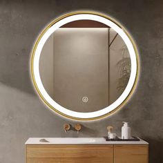 a bathroom vanity with a round mirror above it