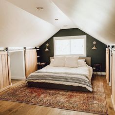 a bed sitting in the middle of a bedroom on top of a rug