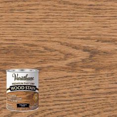 a can of wood stain sitting on top of a wooden table