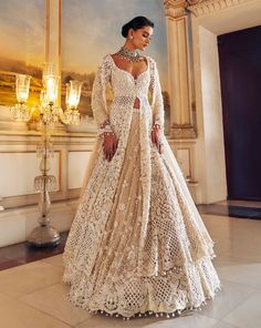 This jacket lehenga set features intricate pearl embroidery interspersed with delicate cut work on a nude base. The full sleeve jacket shows pearl tassels at sleeve hem and is paired with matching embroidered lehenga. The scalloped dupatta shows pearl drops.From Seema Gujral's Falaknuma collection. DELIVERY TIMEPlease allow 8-12 weeks for your outfit to arrive. FABRIC DETAILSNet Professional cleaning only. Jacket And Lehenga, Designer Cream Anarkali Set With Long Sleeves, Long Sleeve Choli With Chikankari Embroidery For Reception, Off White Long Sleeve Sets With Sheer Dupatta, Elegant Long Sleeve Anarkali Set With Sheer Dupatta, Elegant Off White Anarkali Set For Reception, Elegant Off-white Choli With Zari Work, Embellished Beige Anarkali Sets, Elegant Off-white Anarkali Set For Reception