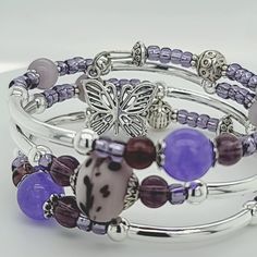 These handmade bracelets with lots of bangles that are easy to wear and simply wrapped around the wrist with no difficult-to-attach clasps. With beautiful, high quality materials, including glass beads, pewter spacers, and adorable charms, 3 Loop Memory Bracelet with a Butterfly and Heart Charm on each end. Stainless steel hypoallergenic memory wire to create a five loop, 3 loop or 1 loop bracelet which will easily adjust to the size of your wrist, and is accented with charms on each end. This a Friendship Bangle Beaded Bracelets, Adjustable Metal Bracelets With Round Beads, Adjustable Bangle With Spacer Beads For Gift, Adjustable Metal Bracelet With Round Beads, Adjustable Bangle Bracelet With Spacer Beads, Hand-strung Metal Bracelet For Gift, Adjustable Bangle With Spacer Beads As Gift, Purple Beaded Bangle Bracelets For Friendship, Hand-strung Metal Bracelet As Gift