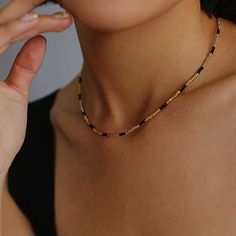 Experience the exquisite beauty of our handcrafted Black Spinel Gold Bean Mini Bead Necklace. Each element is carefully handcrafted to create a refined, elegant look. Add a touch of sophistication to any outfit with this versatile and glamorous necklace. Metal: 18ct Recycled Gold Plated On Brass Gemstone:Black Spinel Pearl: Freshwater Pearl 2.5mm Length: 400-450mm Weight: 5g Elegant Gold Plated Beaded Necklaces With Round Beads, Elegant Gold Plated Round Beaded Necklaces, Elegant Gold-plated Round Beaded Necklaces, Elegant Beaded Chain Necklaces For Jewelry Making, Elegant Adjustable Beaded Necklaces, Elegant Adjustable Beaded Necklace, Elegant Polished Bead Necklaces, Elegant Adjustable Polished Beads Choker, Elegant Chain Necklace With Tiny Beads