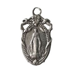 "A vintage French pendant or charm of the Virgin Mary, with an engraved monogram on the back. Late 19th-early 20th centuries. Silver metal (unknown quality). 1 1/8\" by 11/16\"." Antique Miraculous Medal Round Pendant Jewelry, Antique Jewelry With Miraculous Medal Round Pendant, Vintage Collectible Charms With Round Pendant, Vintage Medallion Charms, Antique Miraculous Medal Pendant Jewelry, Vintage Miraculous Medal Round Pendant Jewelry, Historical Engraved Jewelry Gift, Antique Silver Jewelry With Miraculous Medal, Vintage Pendant Jewelry For Commemoration