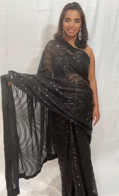 Dazzel like a star in this beautiful party perfect mesmerizing Georgette net saree where elegance meets charm.. Color - Available in 3 colors Black Wine Midnight Blue Fabric - Magnificent and soft ,elegant net made of Georgette Technique - An interplay of fabric and sequin creating a drape that delicately scintillates and transforms in movement and light. The saree is ready to wear with falls, pico and piping finished in finesse , and unstitched blouse fabric is included. Note: Colors that show Ambience Lighting, Net Saree, Georgette Saree, Georgette Sarees, Blouse Fabric, Blouse Dress, The Chic, Saree Blouse, Blue Fabric