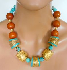 Magnificent handmade beads from Tibet and Moroccogold washed repousse brass beads, "plain" and with inlaid turquoise and handmade round **ber *es** Moroccan beads.  Natural Tibetan turquoise faceted round beads and handmade karat gold over brass fancy cylinder beads from Turkey complete this 1 of a kind stunning statement necklace.  I have shown pics of necklace on mannequin with necklace fastened at shortest length and at longest length.  You can adjust length to fit neckline of garment you are wearing. Necklace fastens with my large handmade signature brass clasp and GP handmade brass chain.  Length adjust from about 19 - 21 inches. Tibetan Turquoise, Handmade Brass, Bead Shop, Handmade Beads, Brass Chain, Natural Beads, Tibet, Round Beads, Morocco