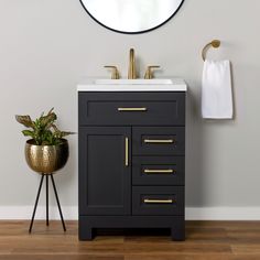 a bathroom with a sink and mirror next to a potted plant on the floor