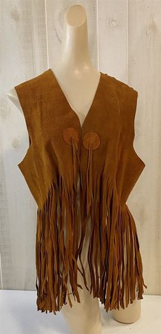 We are offering this vintage fringed suede vest (once worn by a rock band) just in time for the summer music festival season. (Think Coachella!) With its earthy brown soft leather fringe and tie front this vest gives a fun hippie vibe. The tag says mens but does not offer a size (appears to be a small to medium) and could be worn by anyone. Take a look at the pictures for the best description. A photo is as good as a thousand words and is the best description of cosmetic condition. Use your ZOOM Western Vests, Summer Music Festival, Western Vest, Front Fringe, Summer Music Festivals, Vintage Fringe, Fringe Vest, Suede Vest, Leather Tie