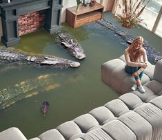 a woman sitting on top of a couch in a living room filled with water and alligators