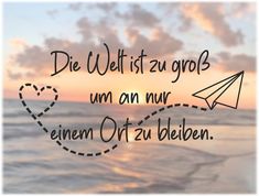 a message written in german on the beach with an airplane flying over the ocean at sunset