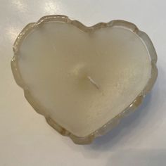 a candle in the shape of a heart