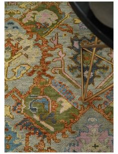 a close up view of a rug with various colors and designs on it, including an intricate